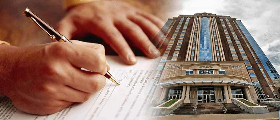 A man signing a contract with a pen, representing Headley Legal Support Services.