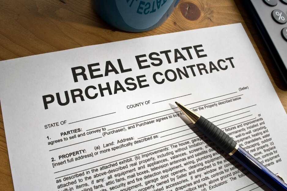 Close-up of Real Estate Purchase Contract paper.