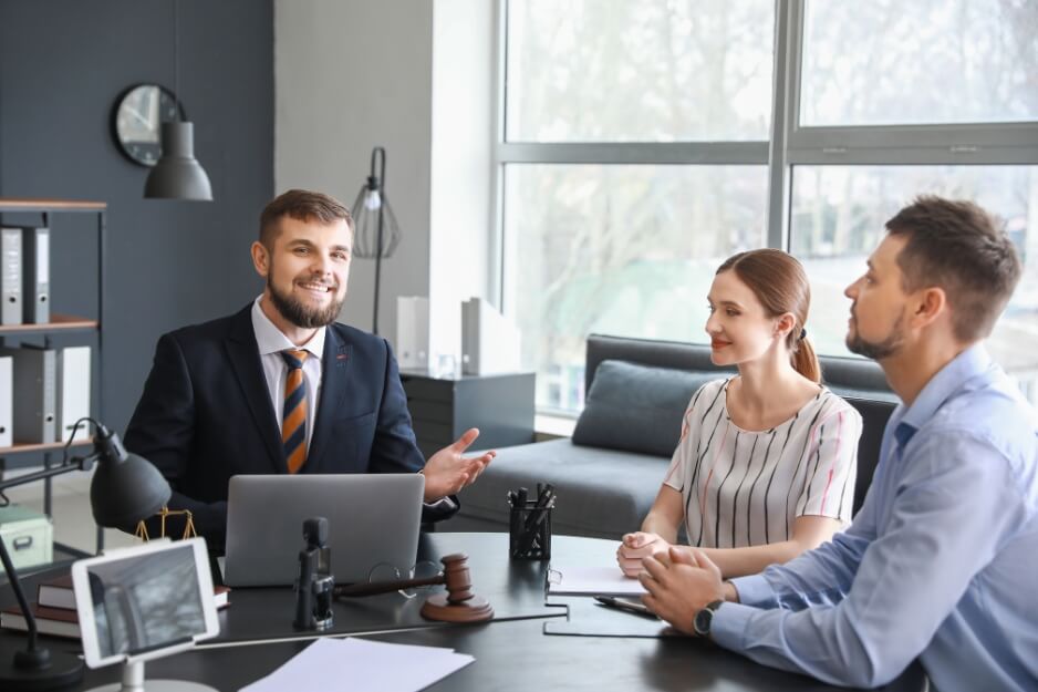 Happy legal professional providing support and guidance to clients during an office meeting.