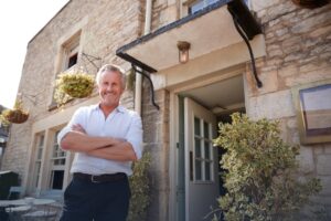Happy Landlord in Front of a Clean, Vacant Property.