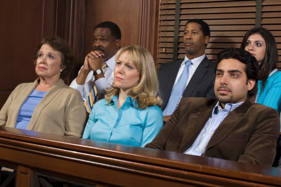 Close-up of serious jury members seated during legal proceedings.